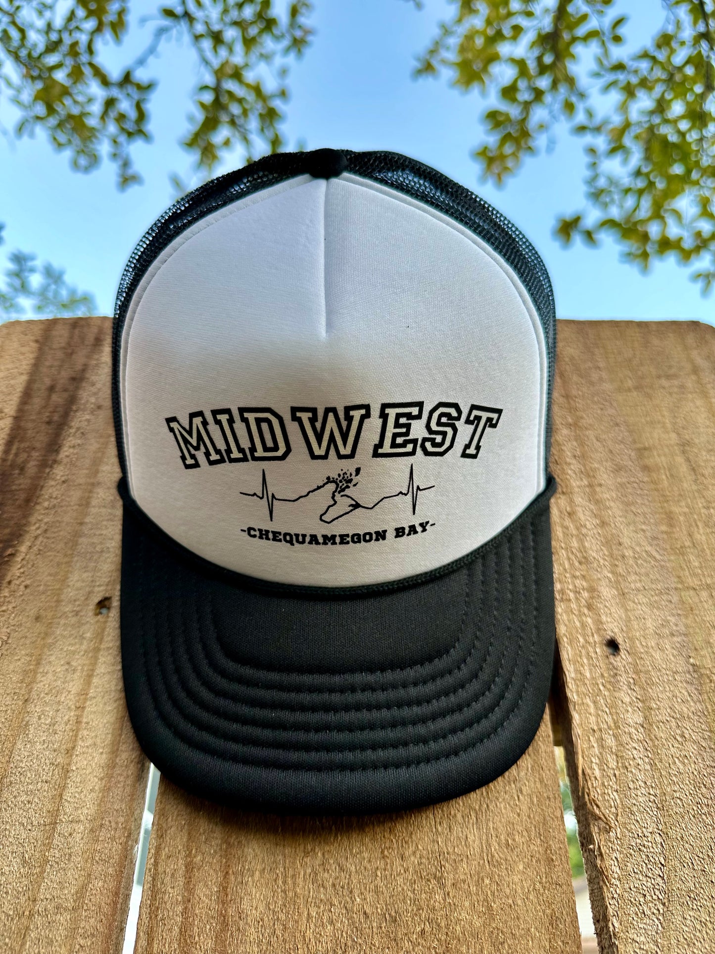 Black and white Midwest foam trucker hat with Chequamegon Bay